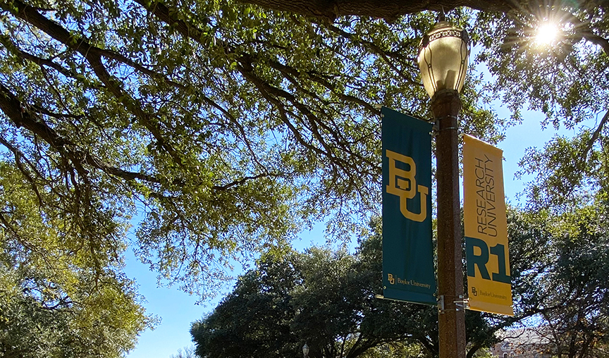 green and gold banners on a lamp post
